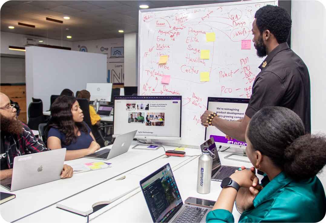 happy-young-african-american-speaker-pointing-computer-screen-with-diagrams