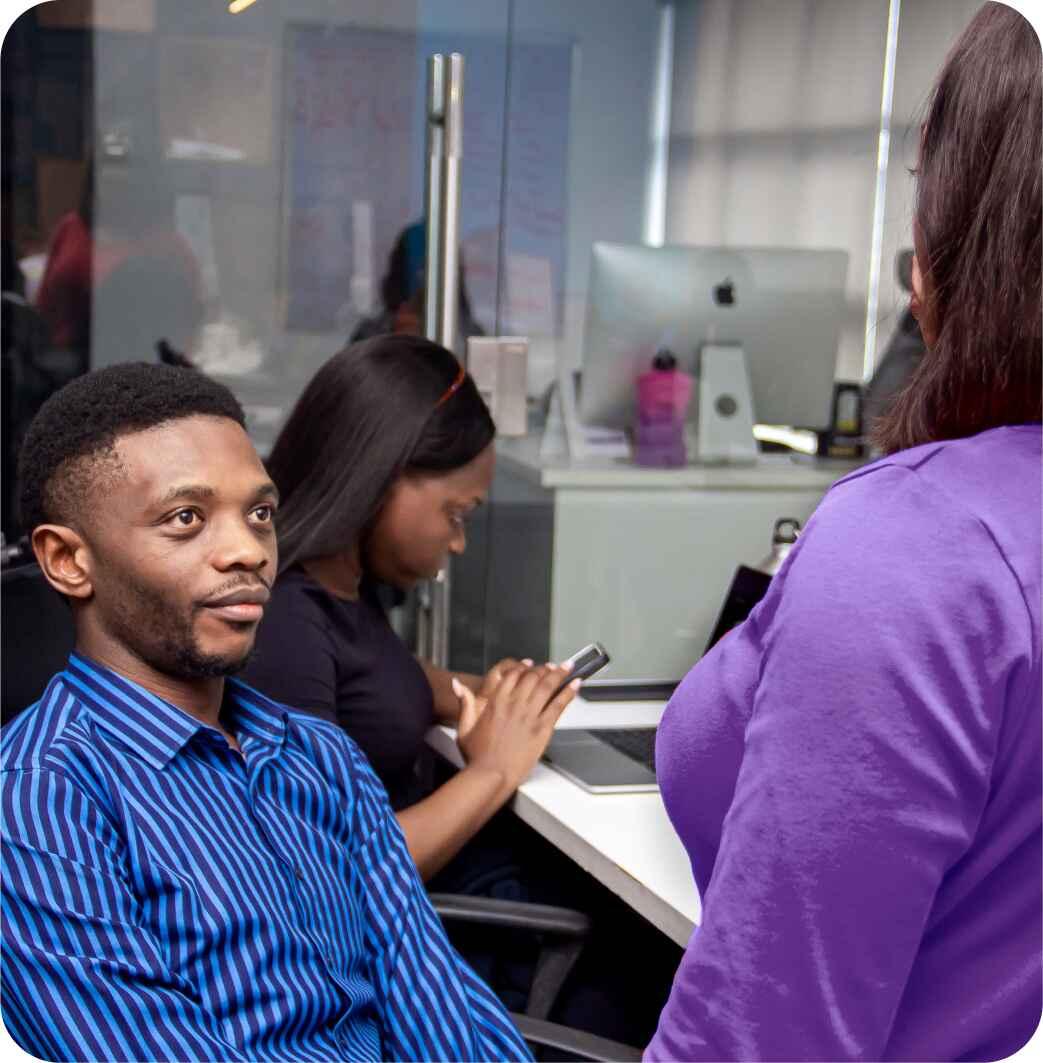 happy-young-african-american-speaker-pointing-computer-screen-with-diagrams